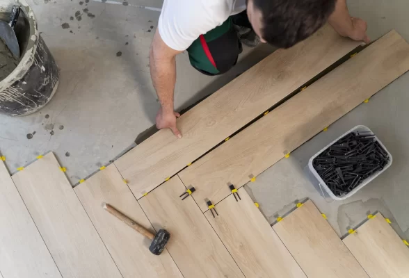 top-view-man-tiling-floor top-view-man-tiling-floor
